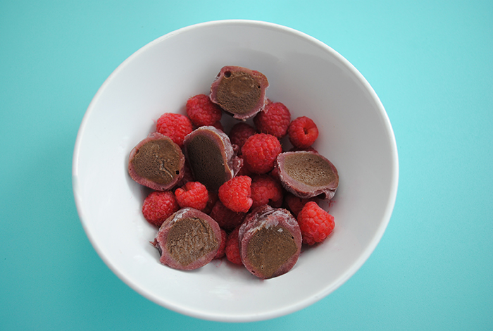 perfectlyfree Non-Dairy Raspberry Chocolate Ice Cream Bites in a bowl with fresh raspberries