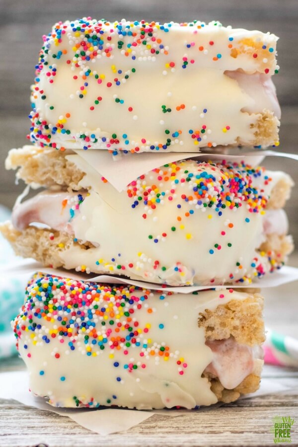 Stack of Gluten-Free Vegan Rice Crispy Ice Cream Sandwiches Dipped In Chocolate and Sprinkles