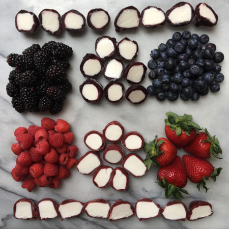 Platter of fresh fruit and perfectlyfree frozen bites sliced in half
